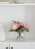 pink peony arrangement on bookcase
